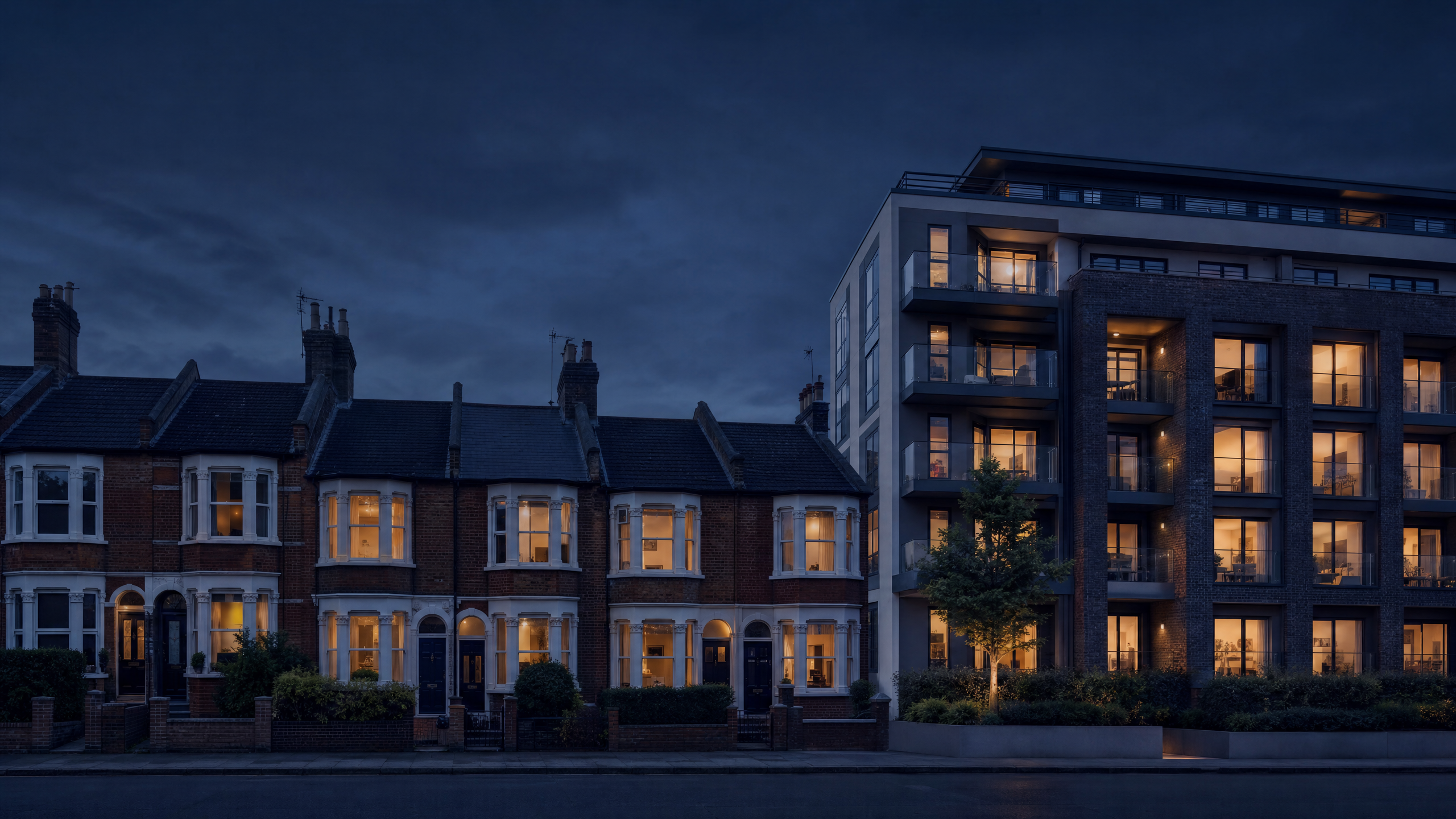Row of UK terraced houses and modern apartment block at dusk — property portfolio insurance